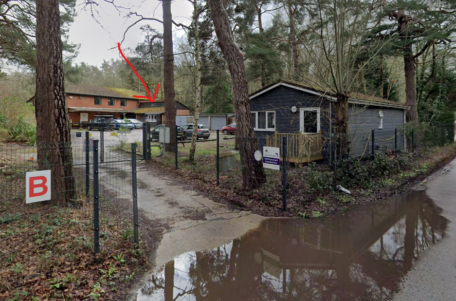 A picture of the entrance to the runway's end shop, the red arrow highlights the building the shop is in.